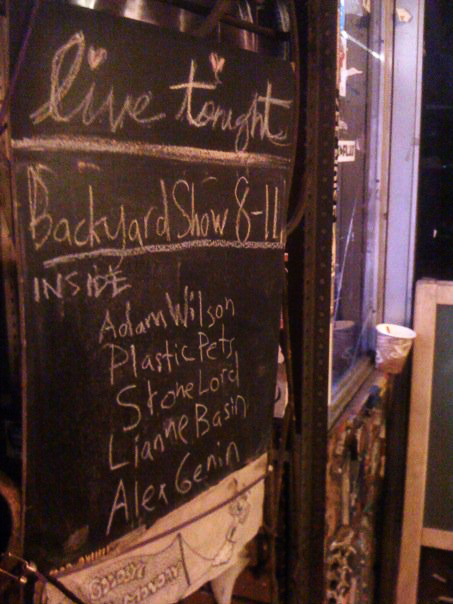 adams wilson on the sandwich board outside a venue in New York City